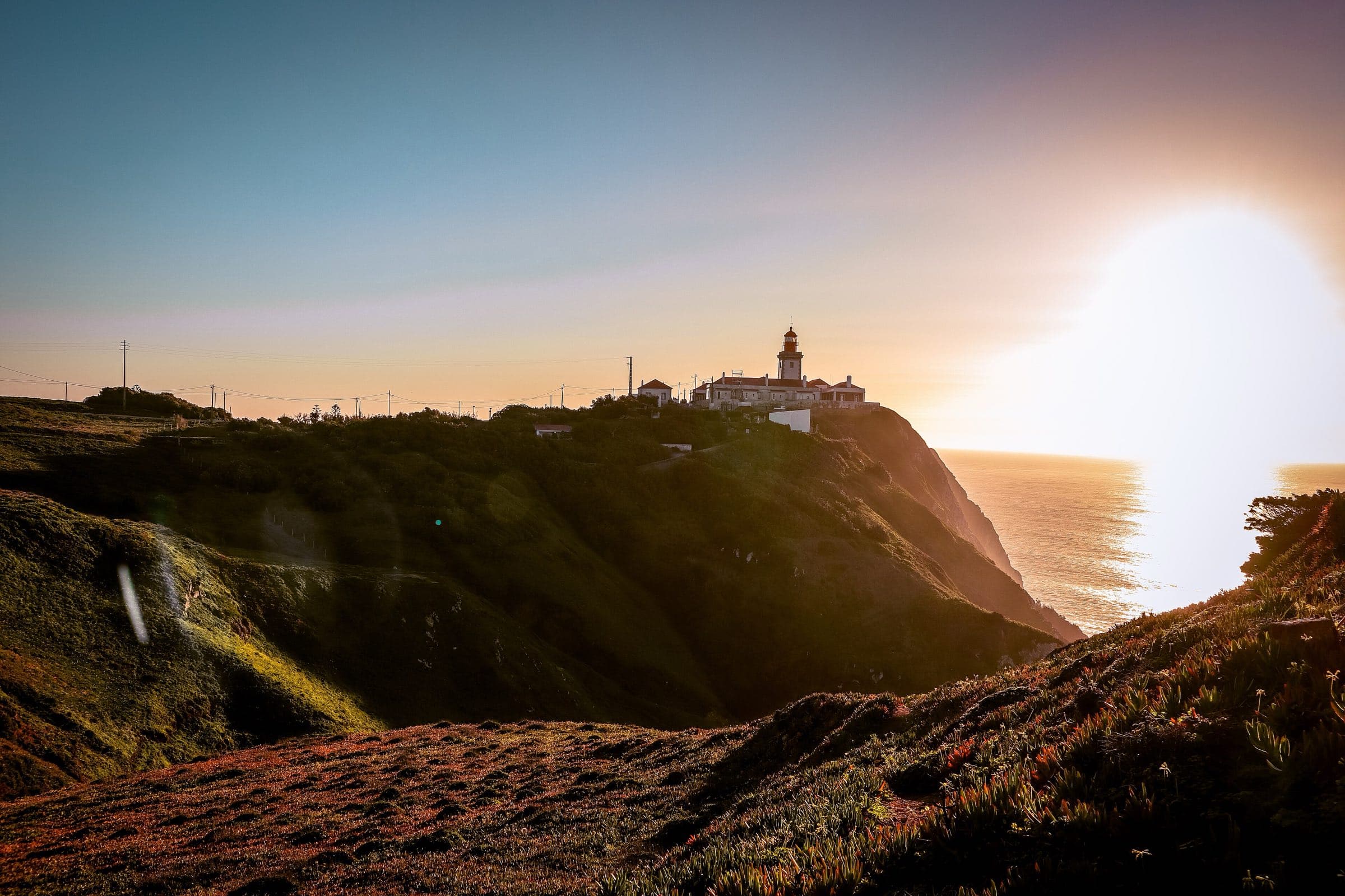 The Cabo da Roca lighthouse above the Atlantic at golden hour, the edge of Europe